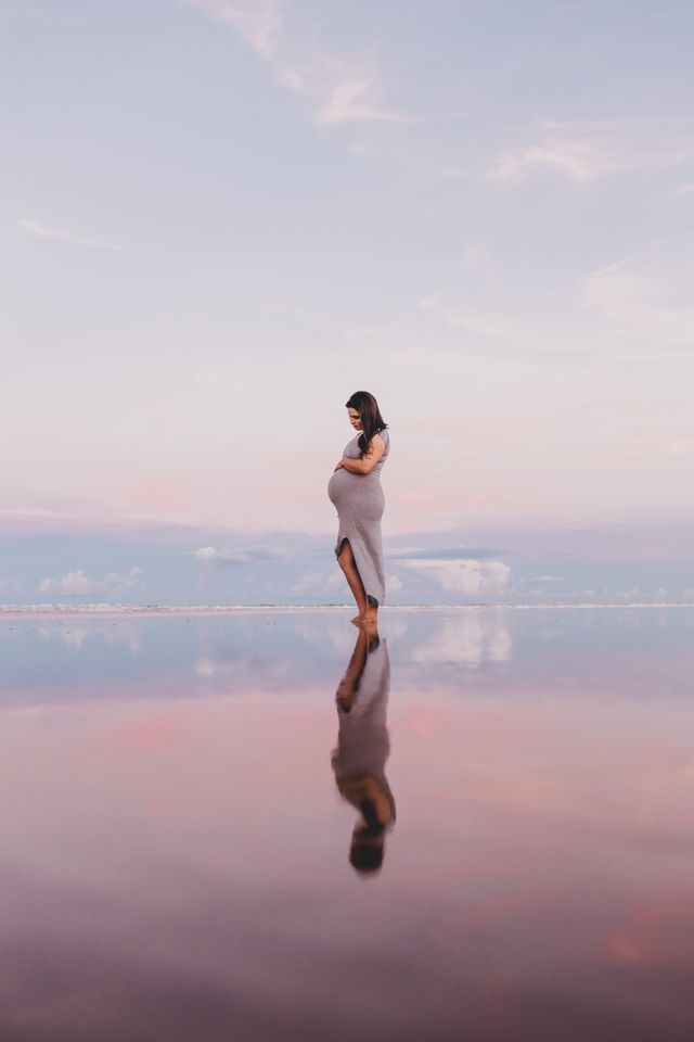 Apnoia-photo d'une femme enceinte au coucher du soleil sur une plage